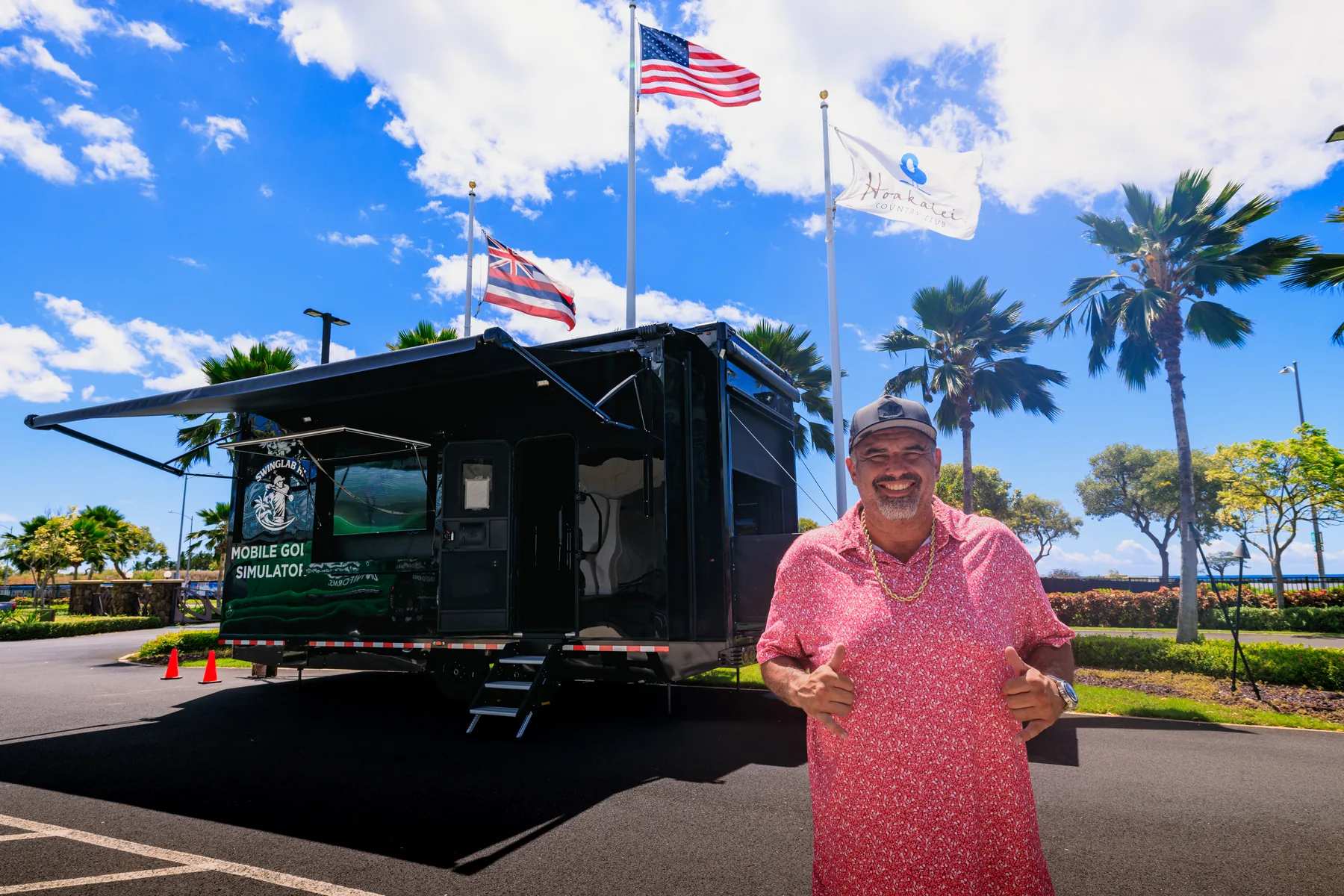 Daren Kawika Martin welcoming guests in front of the open SwingLab trailer at a club on Oahu