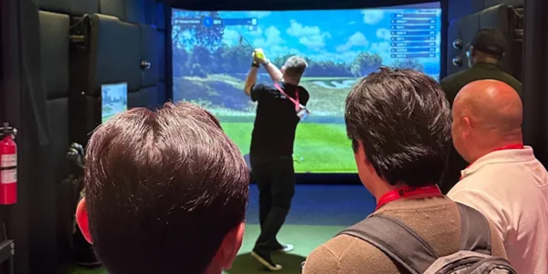 Guests playing the TrackMan simulator inside the trailer
